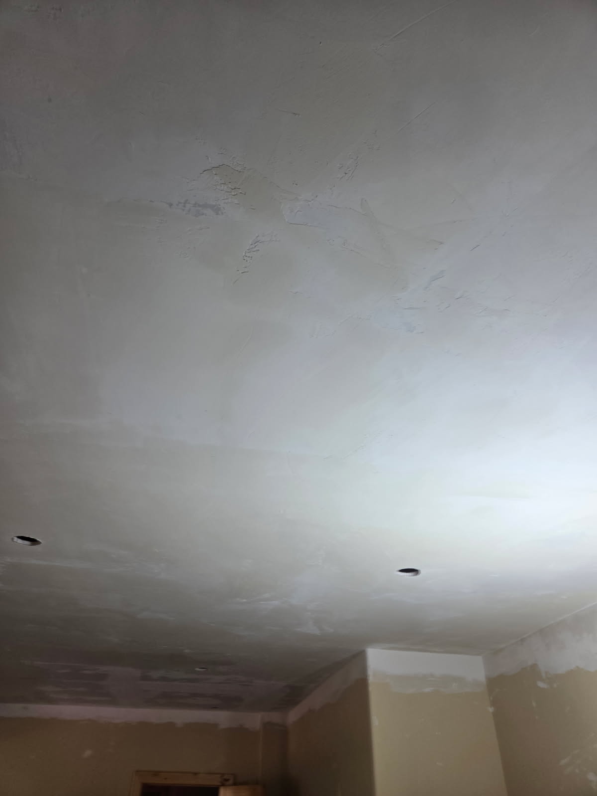 Freshly textured drywall ceiling with recessed light cutouts by A1M Construction
