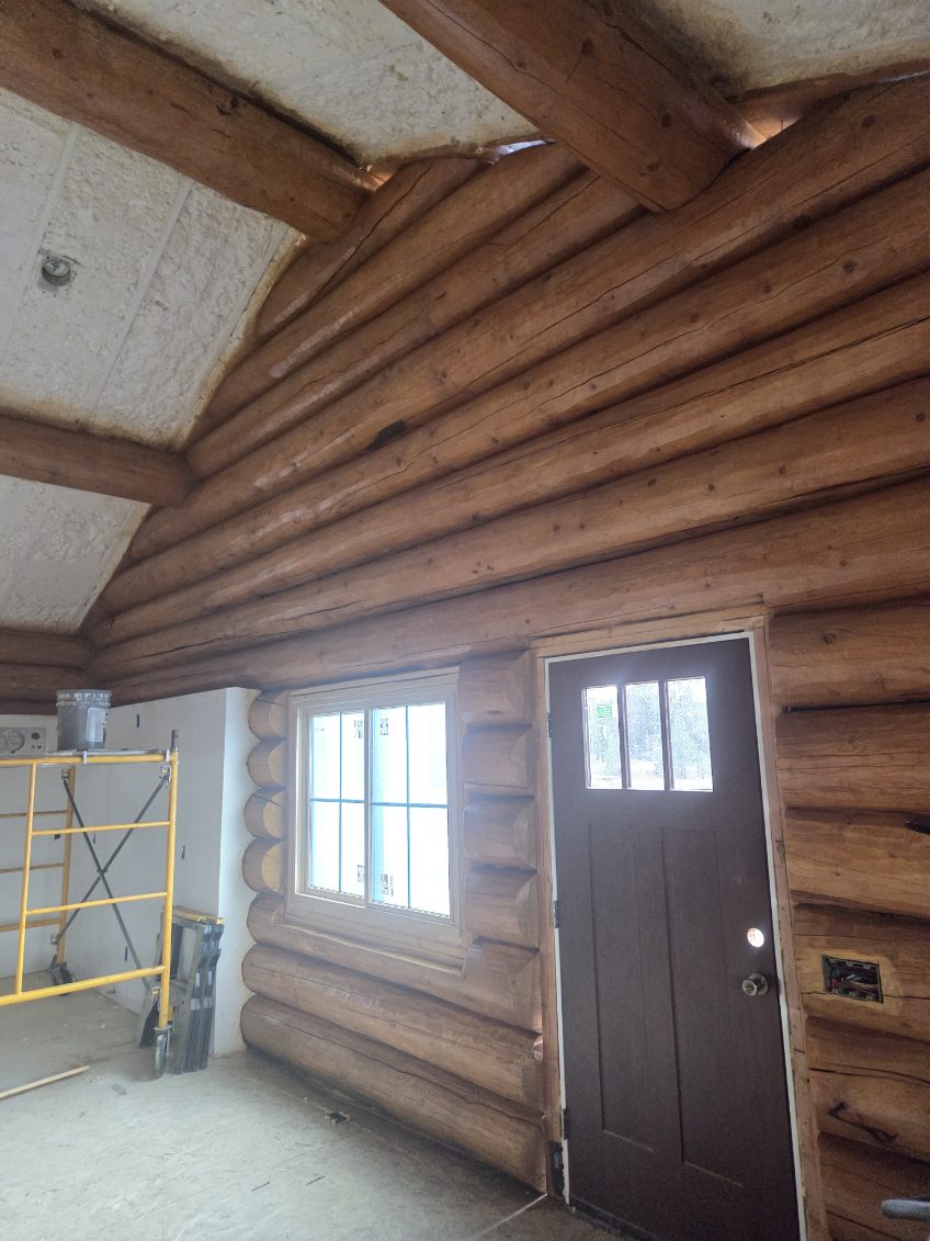 Exterior door and window installed in a log wall by A1M Construction
